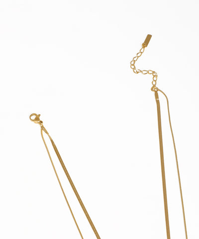 Minimalist layered gold necklace featuring pearl pendant and crystal accent