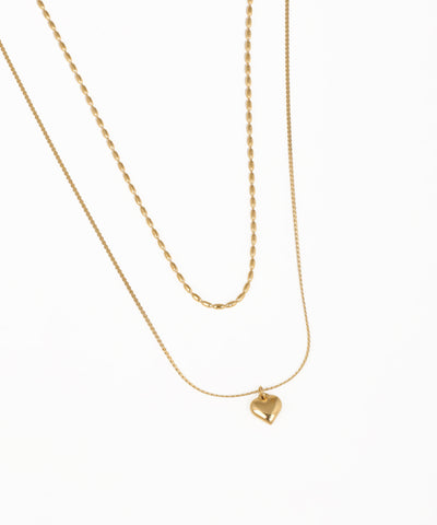 Dual chain layered necklace with polished heart pendant in gold finish