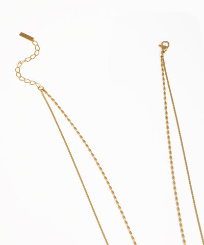 Layered heart pendant necklace with double gold chain design