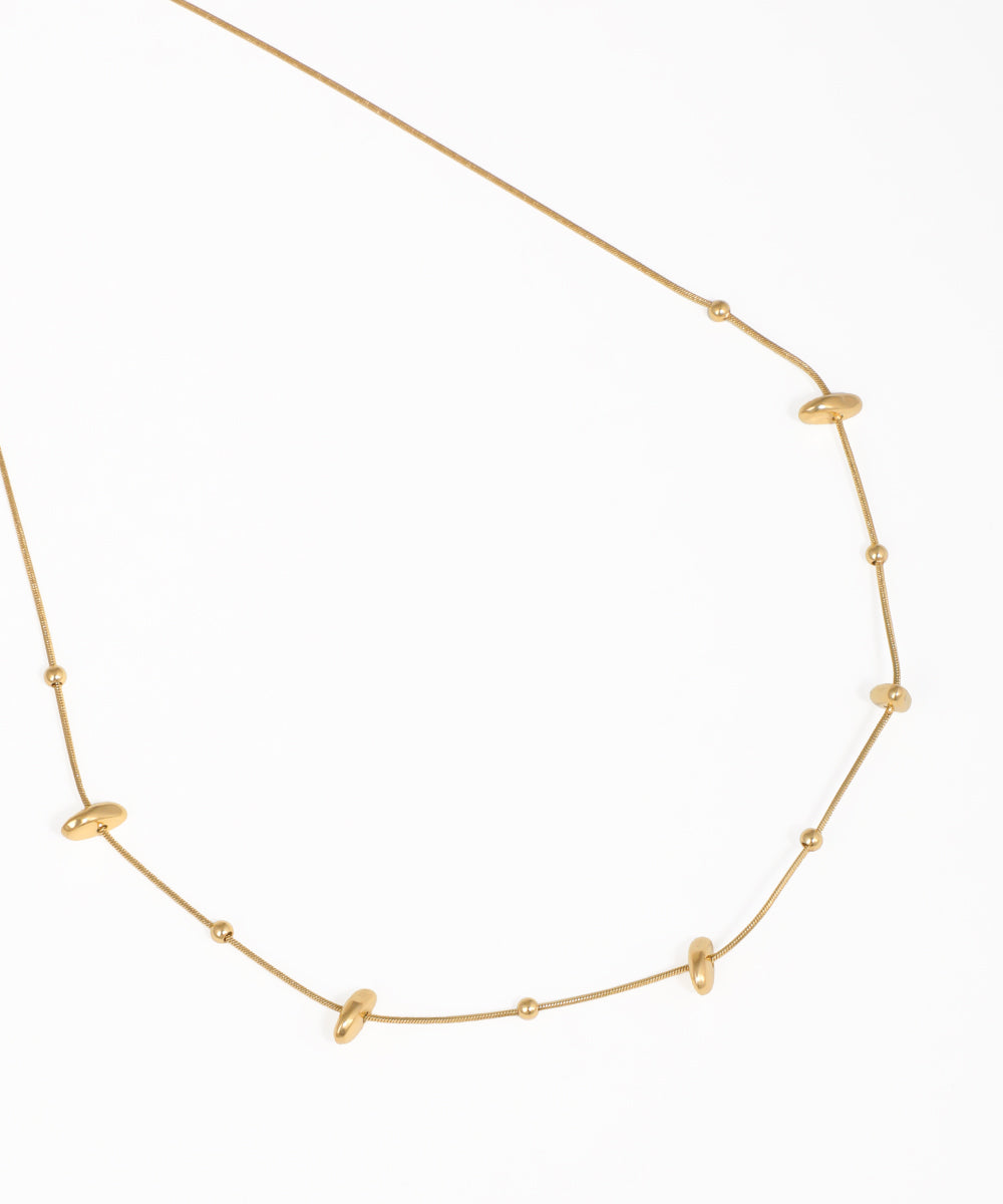 Dainty gold necklace with organic-shaped bead details