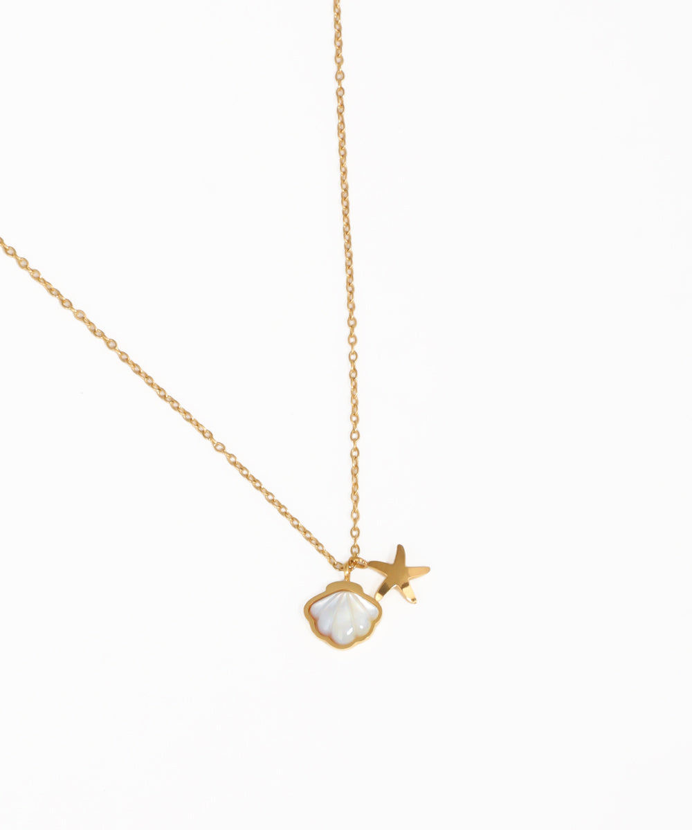 Ocean-inspired shell and star charm necklace with gold-tone chain