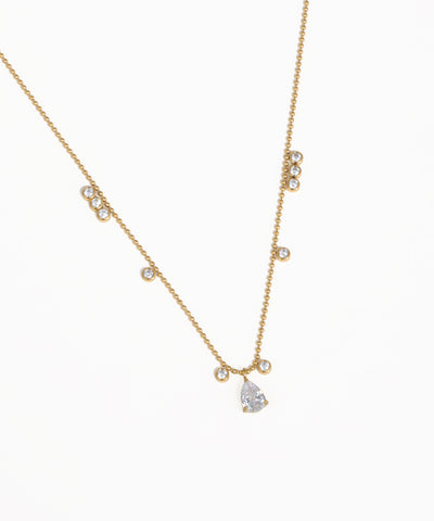 Delicate gold chain necklace with crystal stone accents and drop pendant