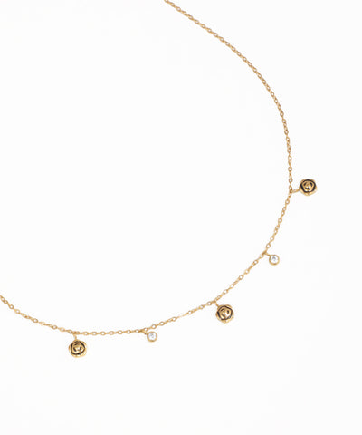 Dainty charm necklace with crystal stone details and delicate gold-tone chain
