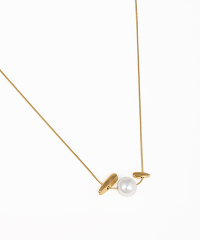 Modern abstract bar accent necklace with gold-tone chain and geometric design