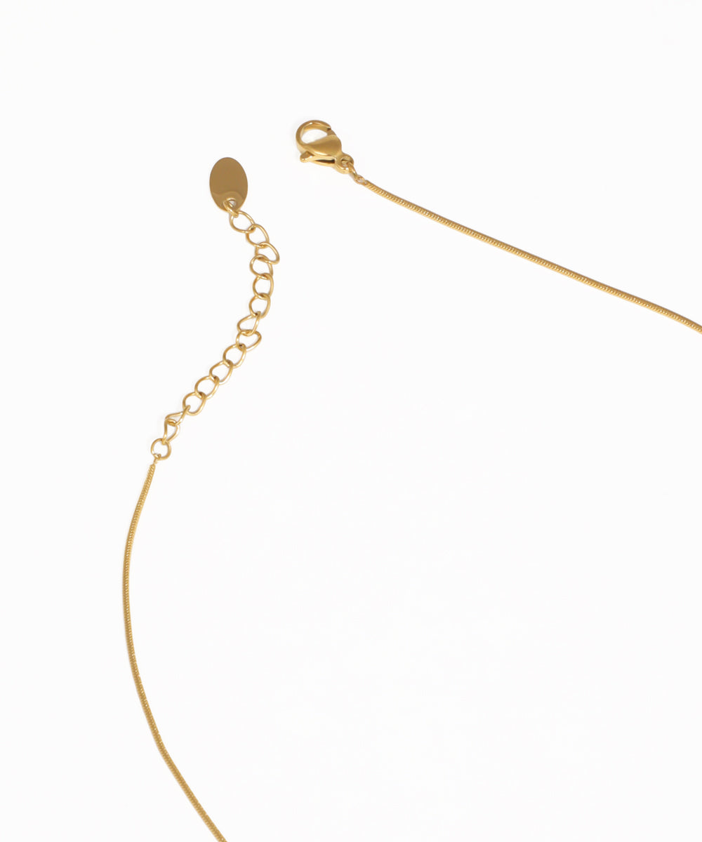 Gold abstract bar pendant necklace with contemporary minimalist styling