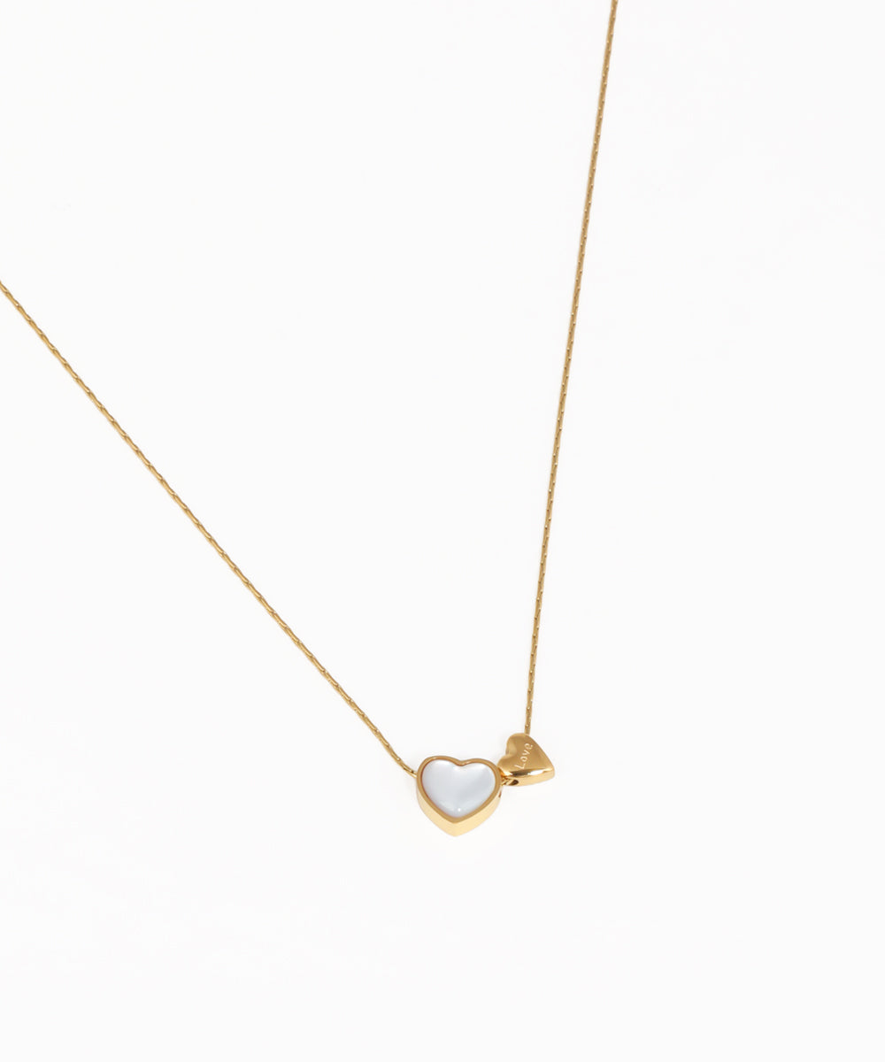 Delicate heart charm necklace with gold-tone chain and polished heart pendant