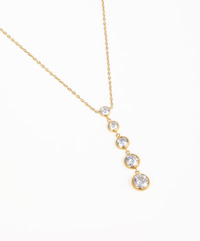 Sleek minimalist stone drop necklace with graduated crystal pendants and gold-tone chain