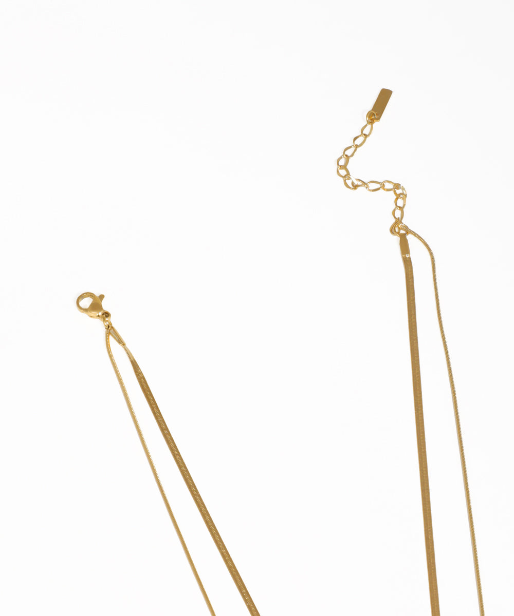 Gold layered snake chain necklace featuring a solitaire stone pendant