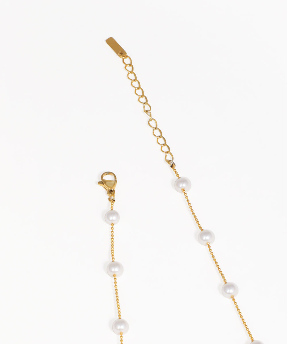 Gold beaded necklace with dangling crystal charms and fine chain