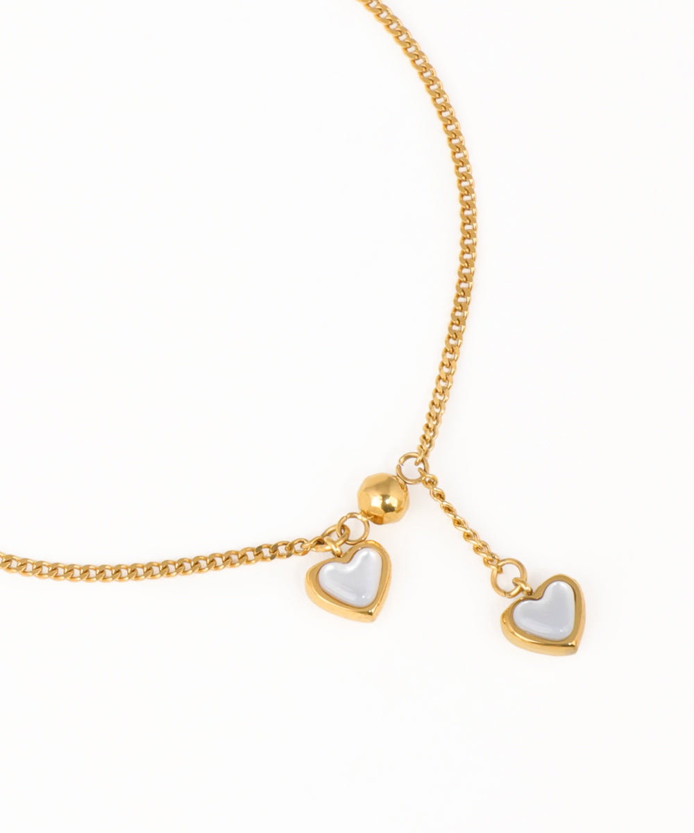 Gold chain bracelet with double heart charms and minimalist design