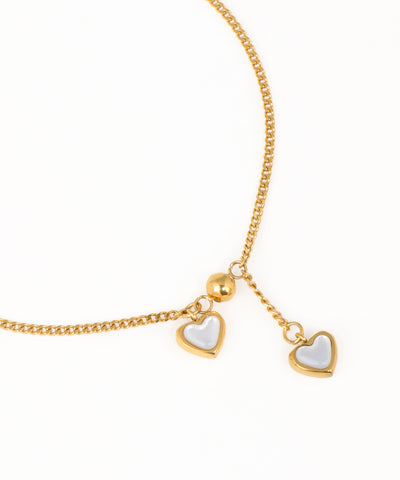 Gold chain bracelet with double heart charms and minimalist design