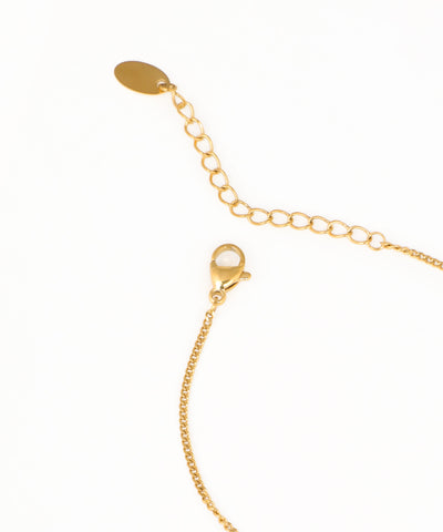 Dainty heart charm bracelet featuring two enamel heart pendants