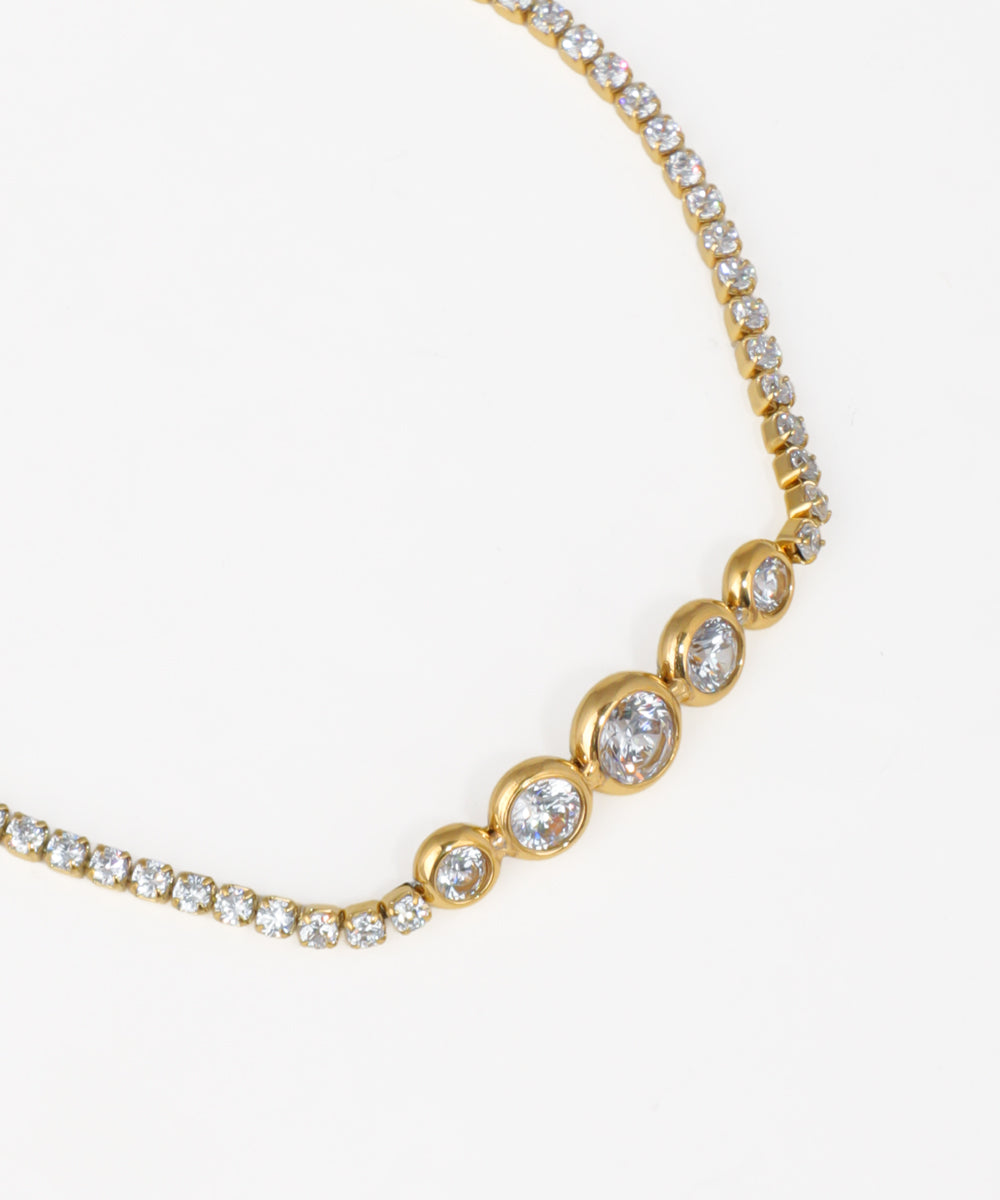 Gold crystal tennis bracelet with graduated bezel-set stones