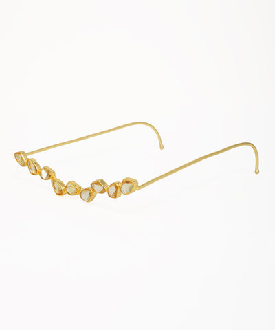Contemporary facelet featuring irregular faceted crystals in a gold setting