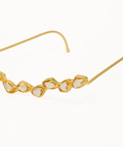 Gold facelet with curved geometric crystal details and minimalist wire frame