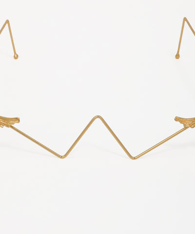 Elegant geometric facelet featuring ornamental bird accents and gold-tone wire