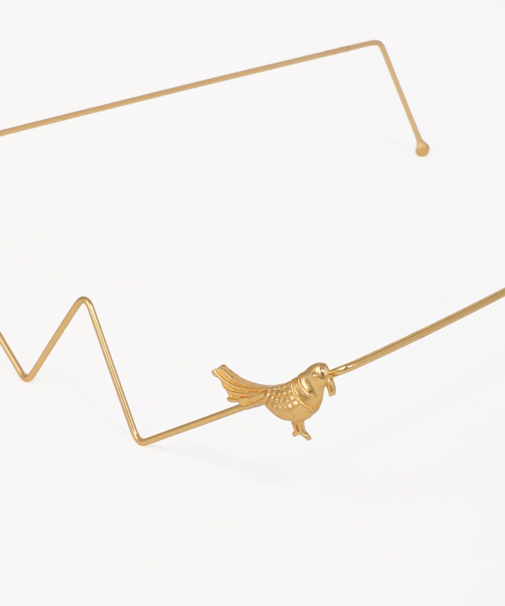 Gold geometric facelet with decorative bird accents and angular wire design