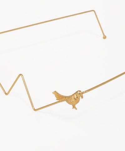 Gold geometric facelet with decorative bird accents and angular wire design