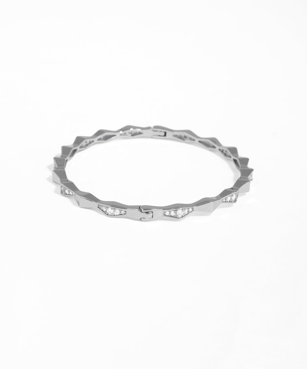 Silver ring with small diamonds on a white background