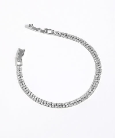 Silver bracelet with clear stones on a white background
