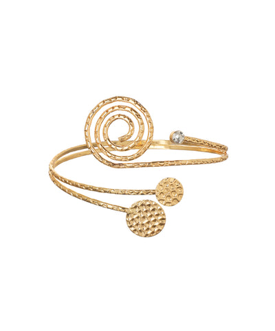 Gold-tone arm cuff with large spiral detail, textured bands, small clear stone, and hammered circular discs.