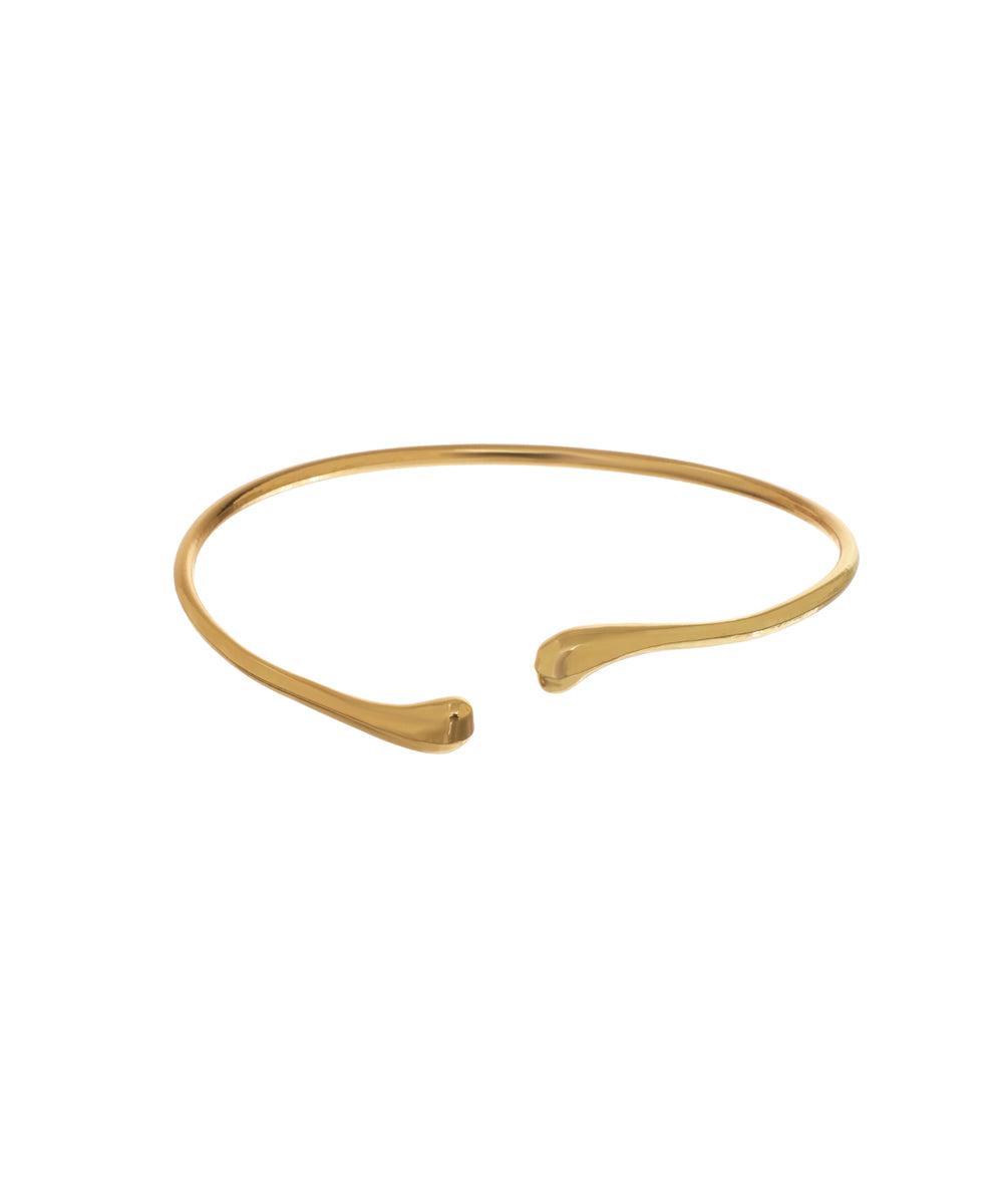 Gold-tone arm cuff with sleek open band design and subtly flared ends