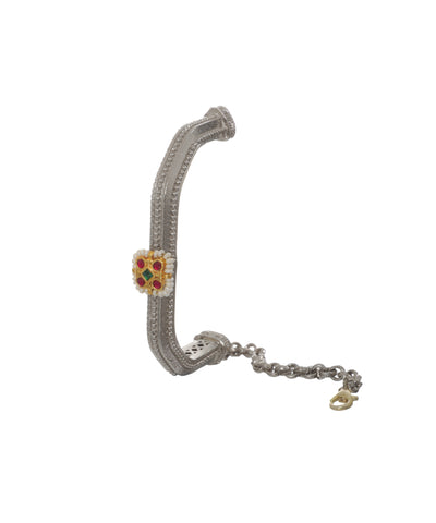 Oxidise cuff bracelet with textured silver-tone finish and central gold-tone element with red, green stones, and faux pearls.