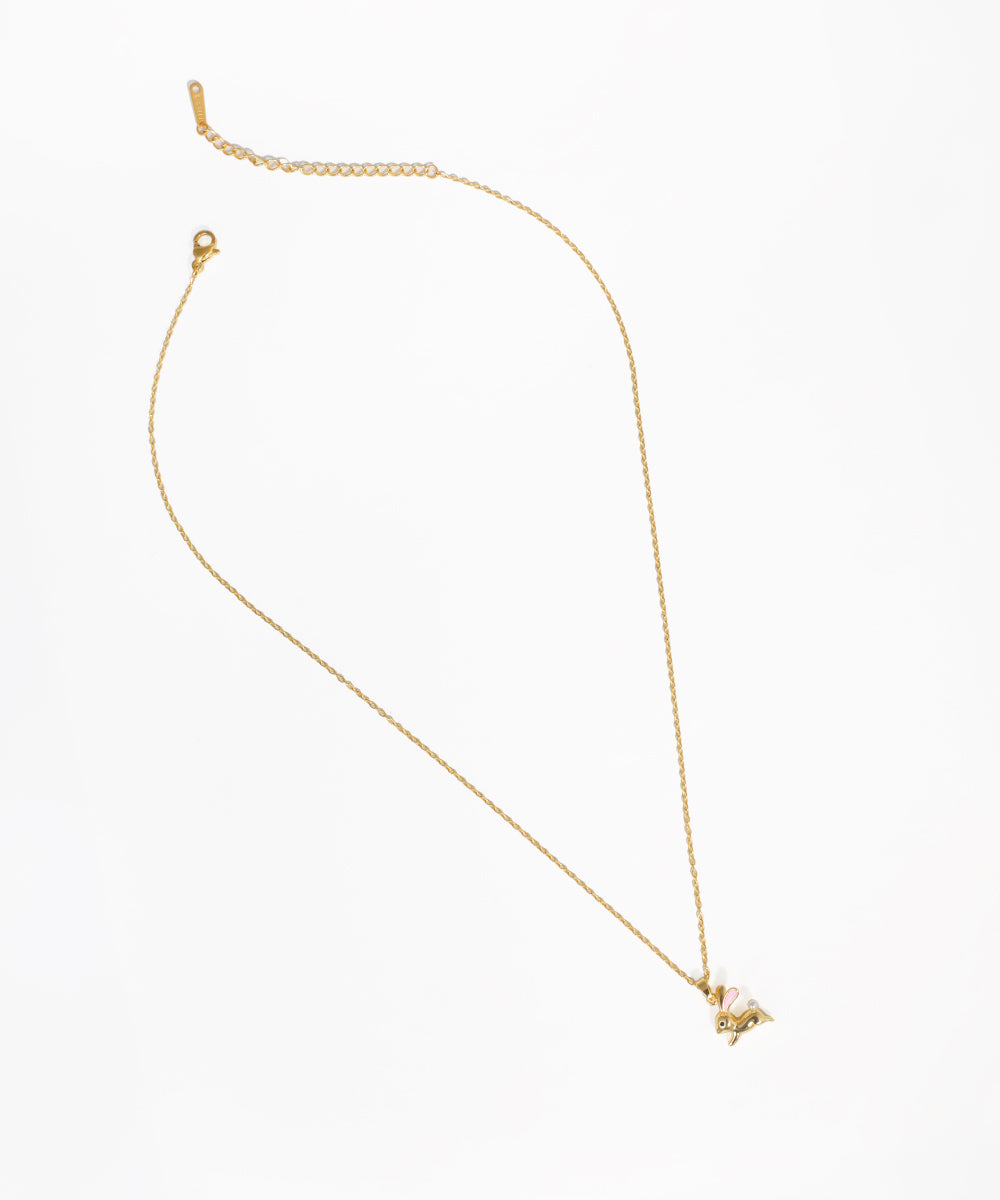 Gold-tone necklace with a small rabbit pendant featuring pink and white accents