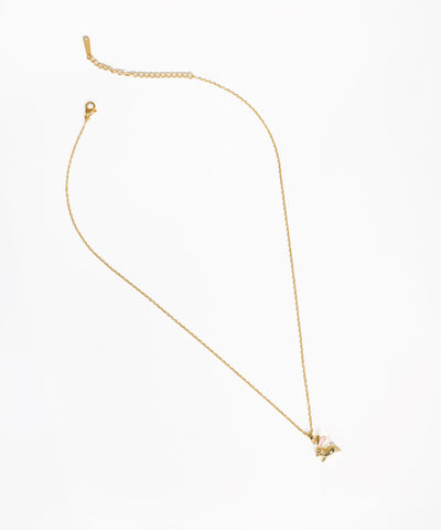 Gold-tone necklace with a small rabbit pendant featuring pink and white accents