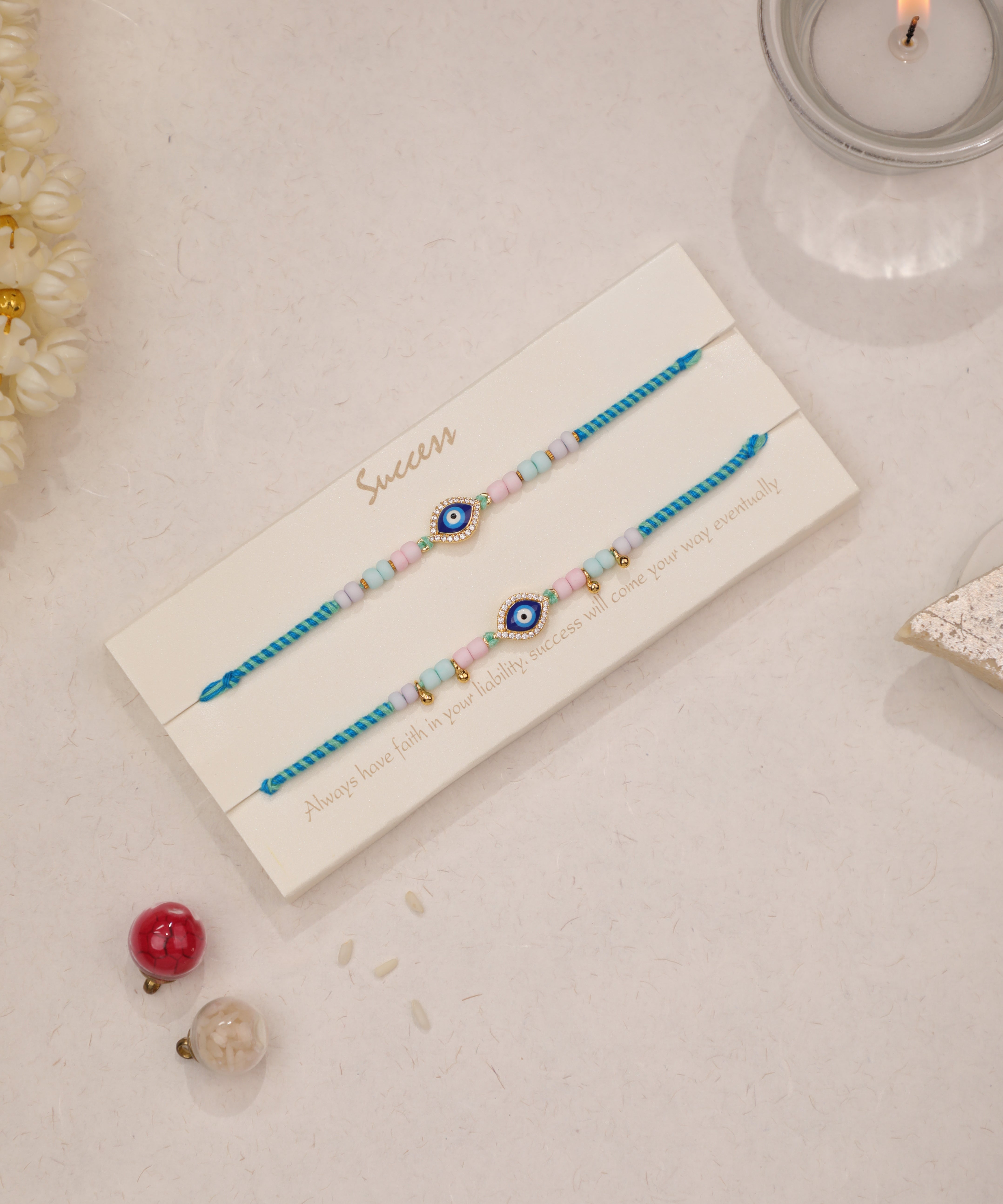 Gold-tone Rakhi set with evil eye charms and pastel beads