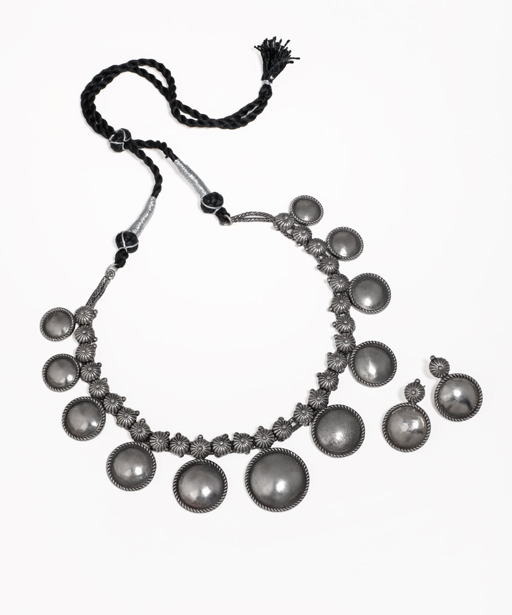 Oxidized silver-tone necklace and earrings with disc and floral motifs