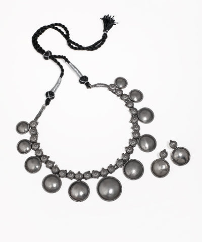 Oxidized silver-tone necklace and earrings with disc and floral motifs