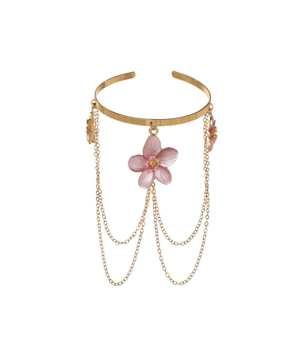 Gold-tone arm cuff with pink floral charms and cascading chains
