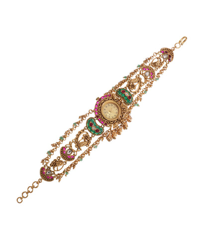 Antique gold-tone Heritage Watch with pink and green enamel, white stones, and multi-tier chain design.
