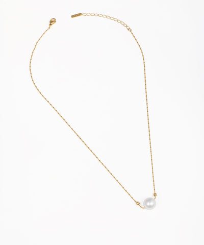 Gold-tone necklace with a delicate chain and a single faux pearl bead
