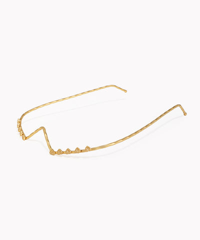 Gold-tone facelet with hammered texture and delicate V-shape motifs
