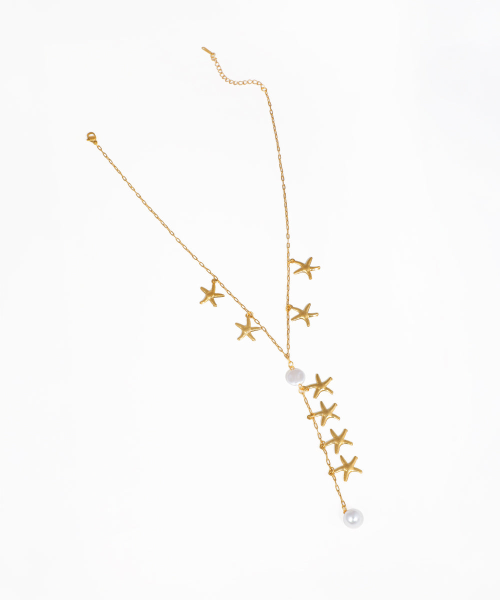 Gold-tone necklace with starfish charms and faux pearls in a lariat Y-drop design