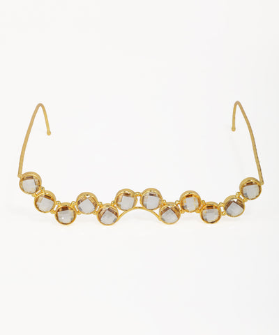 Gold-tone facelet with a wavy line of clear, round, bezel-set details