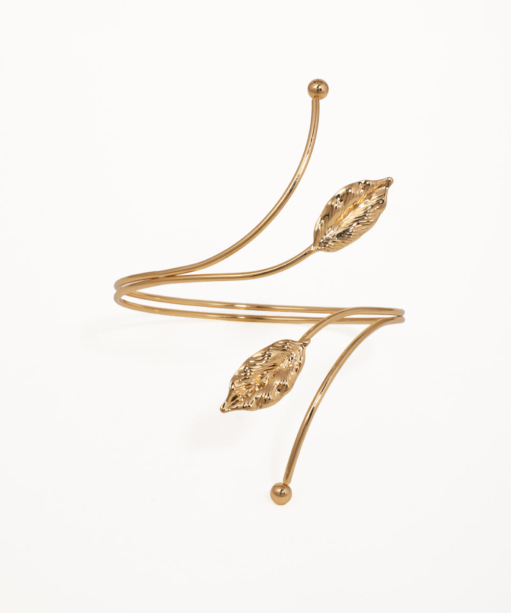 Gold-tone arm cuff with detailed leaf motifs and wraparound design