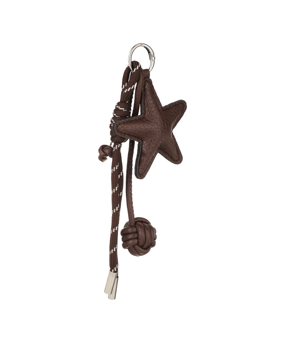 Silver-tone key ring with brown textured star, brown knotted detail, and striped cord bag charm