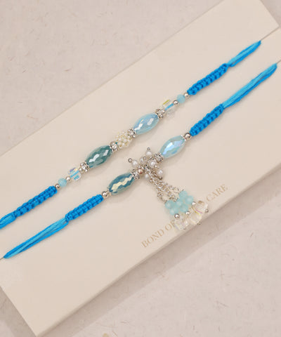 Silver-tone Rakhi set with aqua glass beads, faux pearls, and blue string