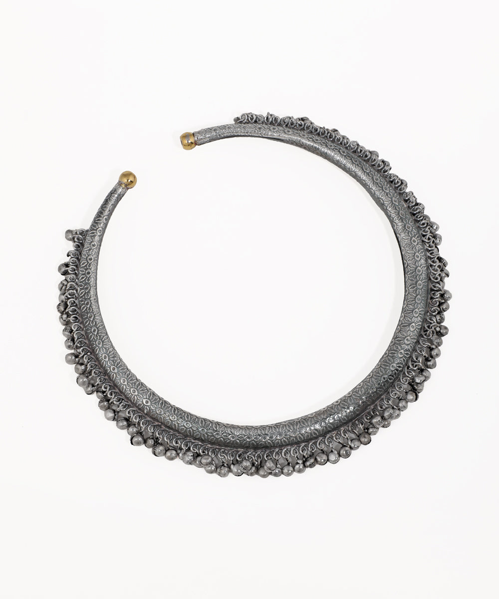 Oxidise hasli necklace with embossed pattern and small hanging bead details, brass-tone cap ends