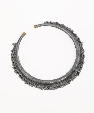 Oxidise hasli necklace with embossed pattern and small hanging bead details, brass-tone cap ends
