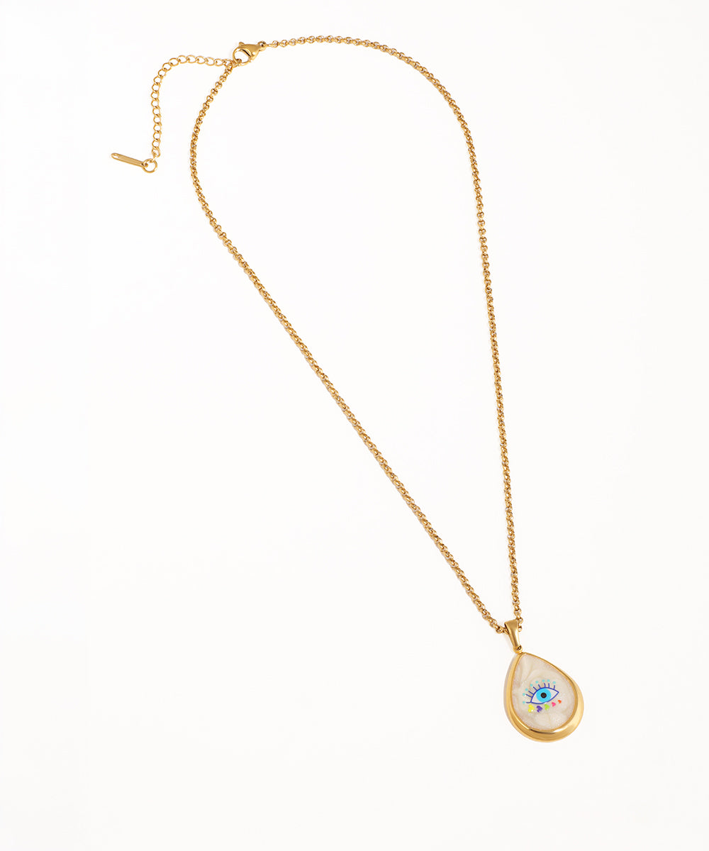 Gold-tone pendant necklace with iridescent teardrop and colorful evil eye design.