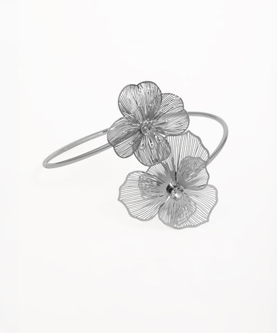 Silver-tone arm cuff with two filigree flowers, each featuring a clear center stone