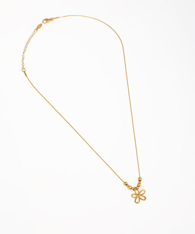 Gold-tone necklace with an openwork floral pendant and three small decorative beads on a delicate chain