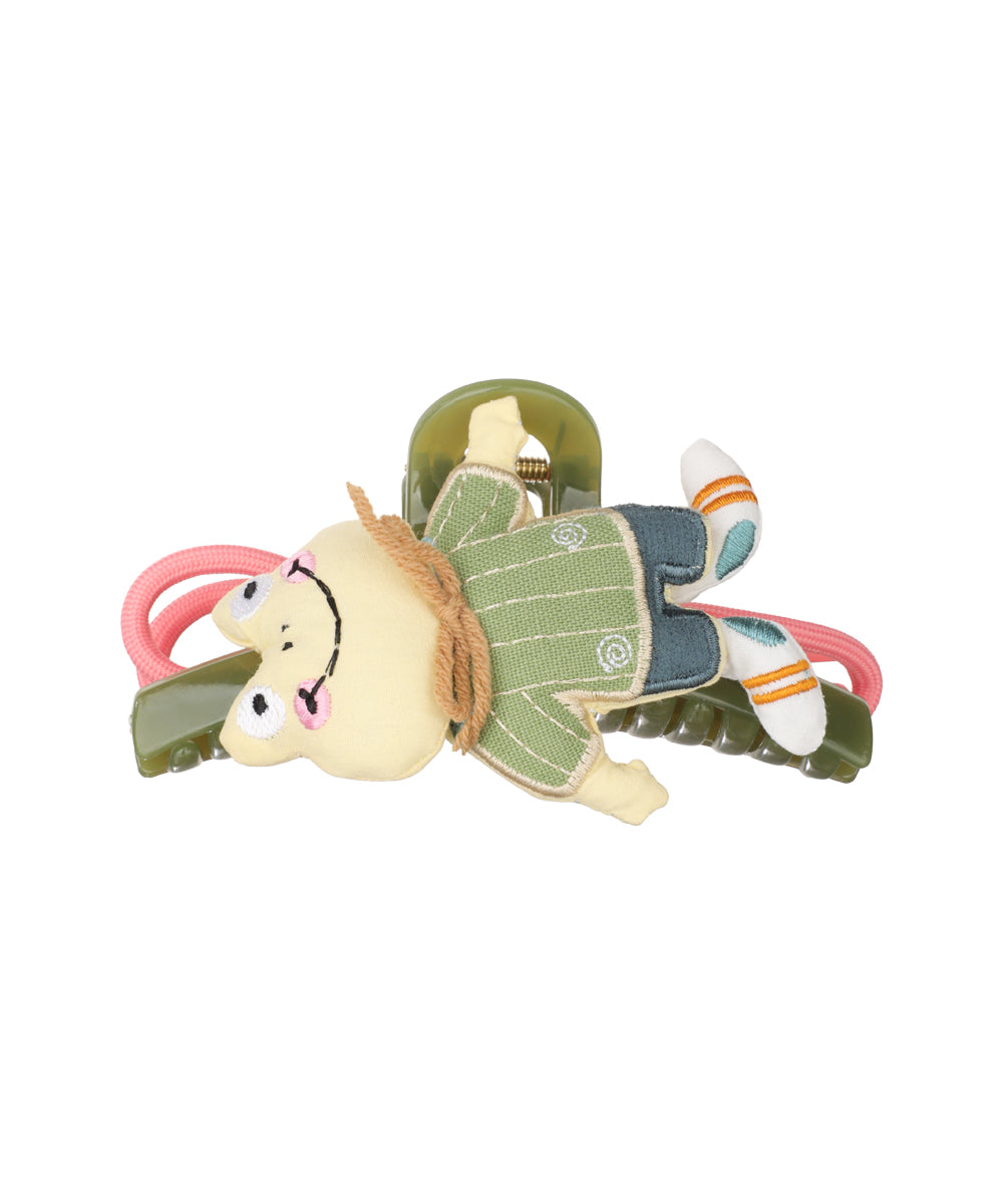Green claw clip with plush yellow cartoon doll character accent.