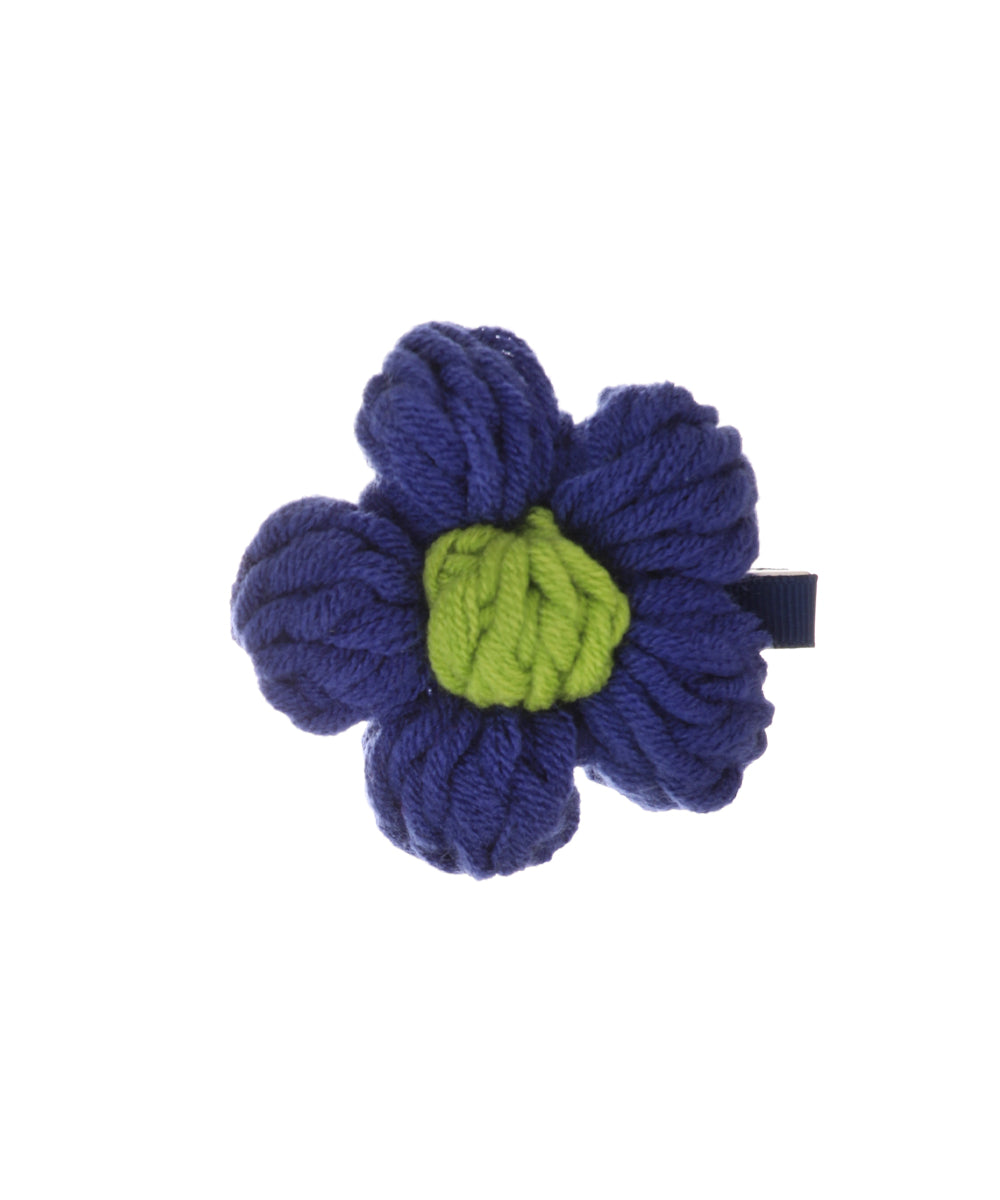 Blue and green crochet flower hair clip with textured yarn petals and center