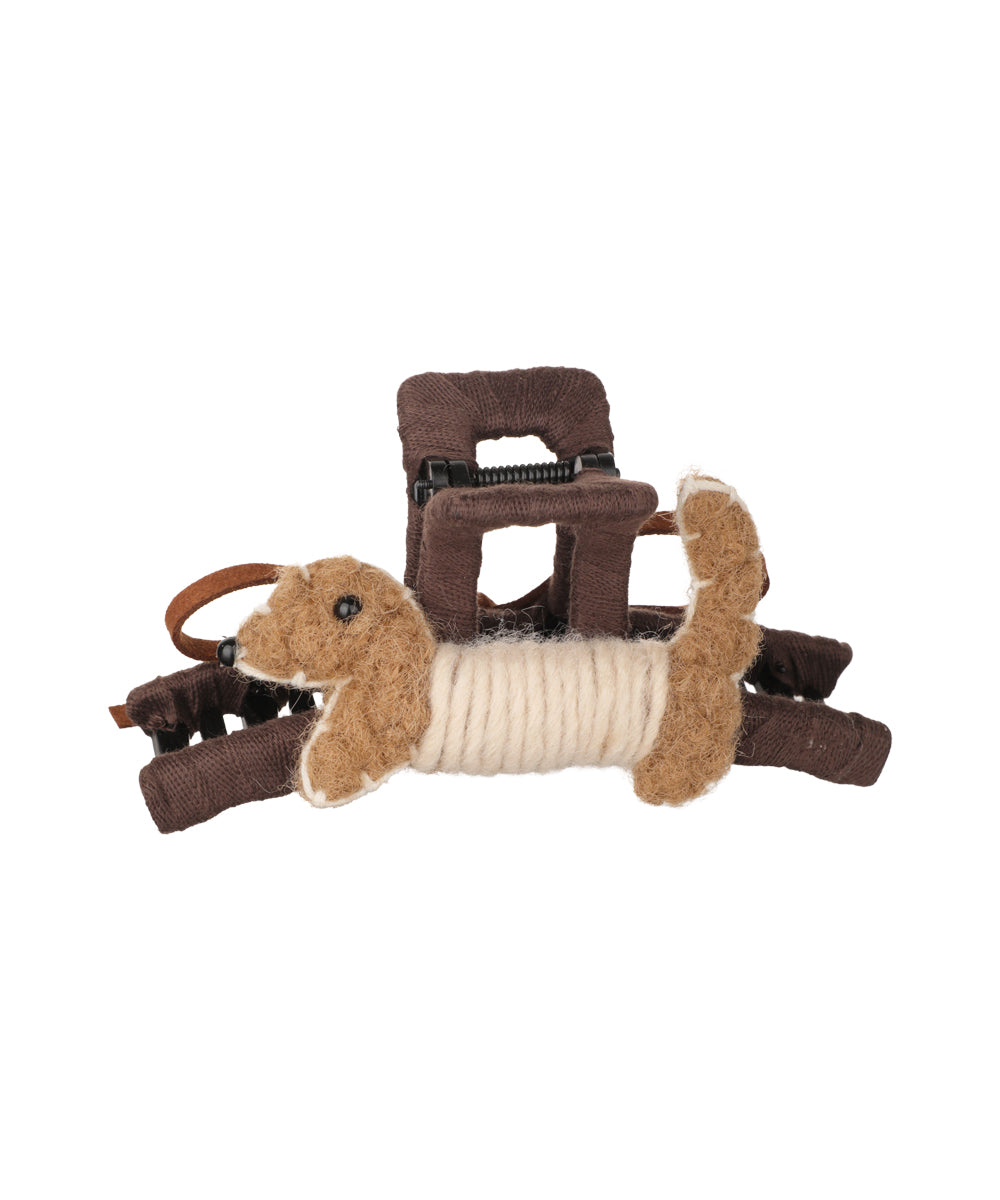 Brown fabric claw clip with an embellished dog figurine and cream yarn detail