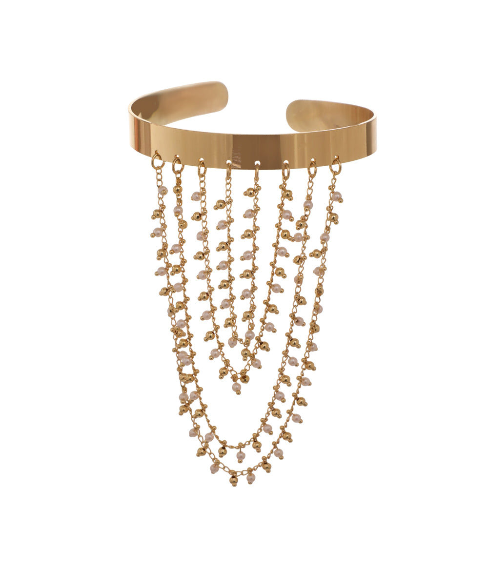 Gold-tone arm cuff with wide band and cascading chains featuring faux pearls and metallic beads